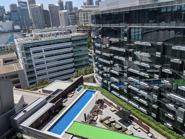 City buildings and a pool courtyard from above