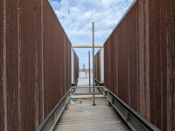 Walkway between evaporative cooler media walls