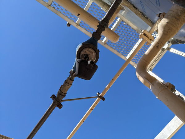 Pipework crossing against a clear blue sky