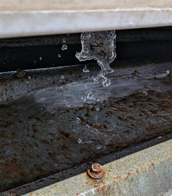 Water trickling over a weathered steel edge